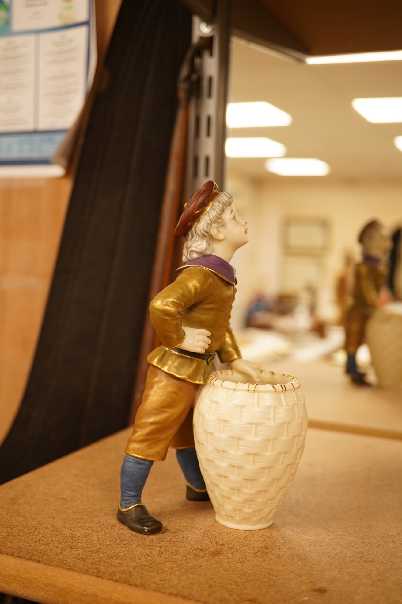 A late 19th century Royal Worcester figure of a boy with basket, 17.5cm high